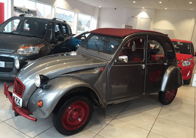 The Team’s Citroen 2CV in the Budgen Motors’ Showroom on Featherbed Lane The Team’s Citroen 2CV in the Budgen Motors’ Showroom on Featherbed Lane