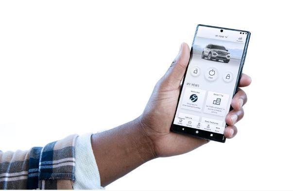 Hand holding a smartphone with the FordPass App open