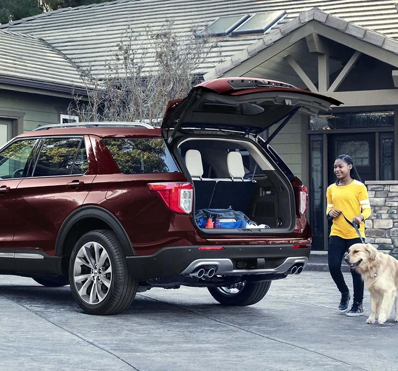 2022 Ford Explorer with truck open. Woman and her dog are about to get in