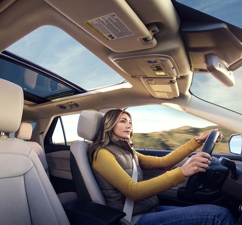 Woman driving a 2022 Ford Explorer. 