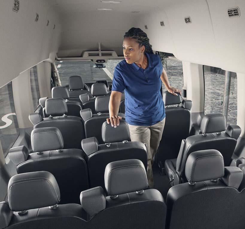 Woman checking all of the seats inside the spacious 2022 Ford Transit Passenger Van