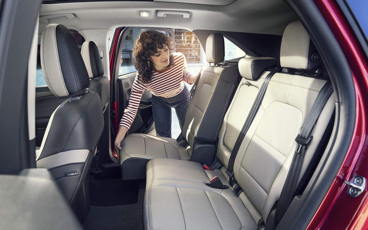 Woman adjusting the Second-Row Sliding Seats, 60/40 Split-Fold Down in her 2022 Ford Escape SE Hybrid