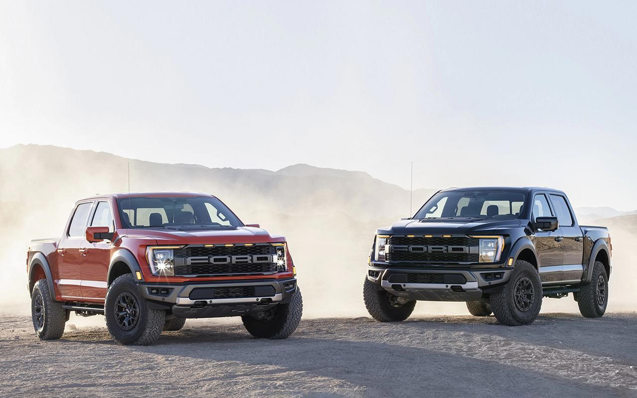 Two 2022 F-150 Raptor® trucks parked on sand