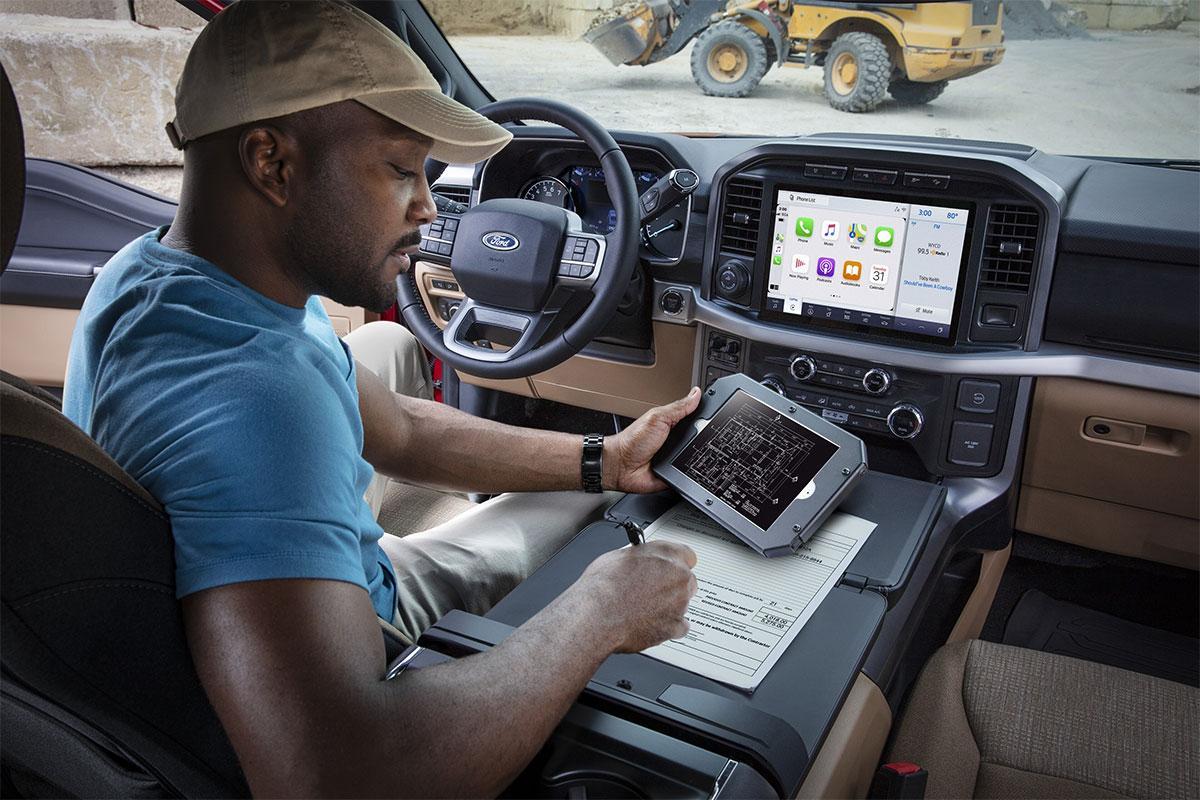 Man sitting inside his 2023 FORD F-150® at a construction site | South Bay Ford