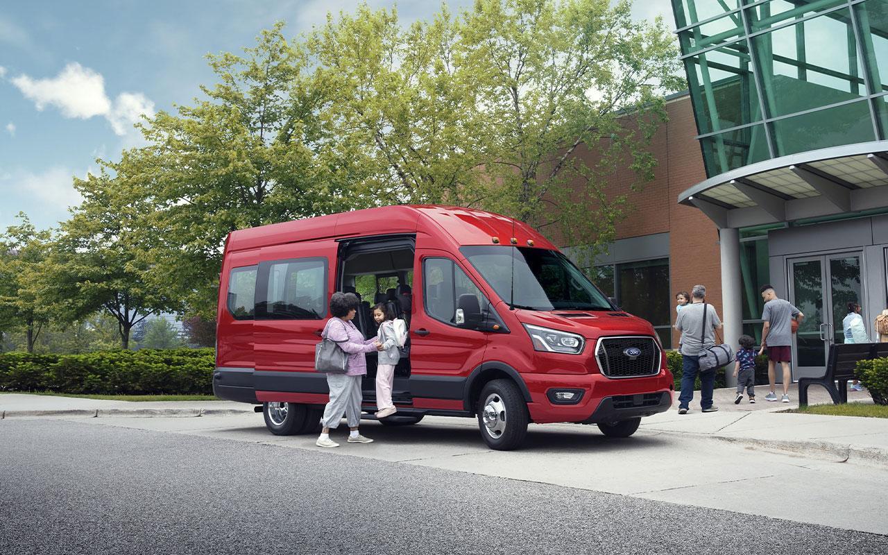 Mom dropping her child off at school getting out of the 2022 Ford Transit Passenger Van 