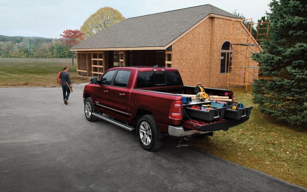 Red Ram truck with construction tools and in-progress house