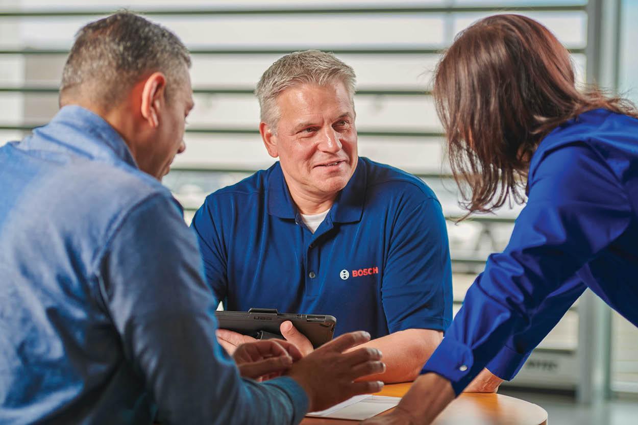 Owners sitting at the table talking business with their Bosch representative. 