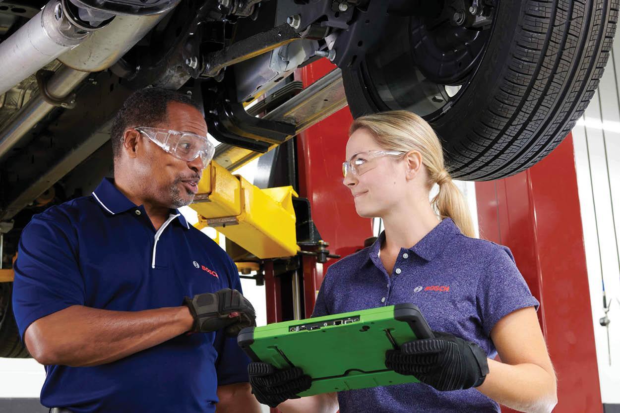 Technician fixing a vehicle at a Bosch Auto Service franchise location. 