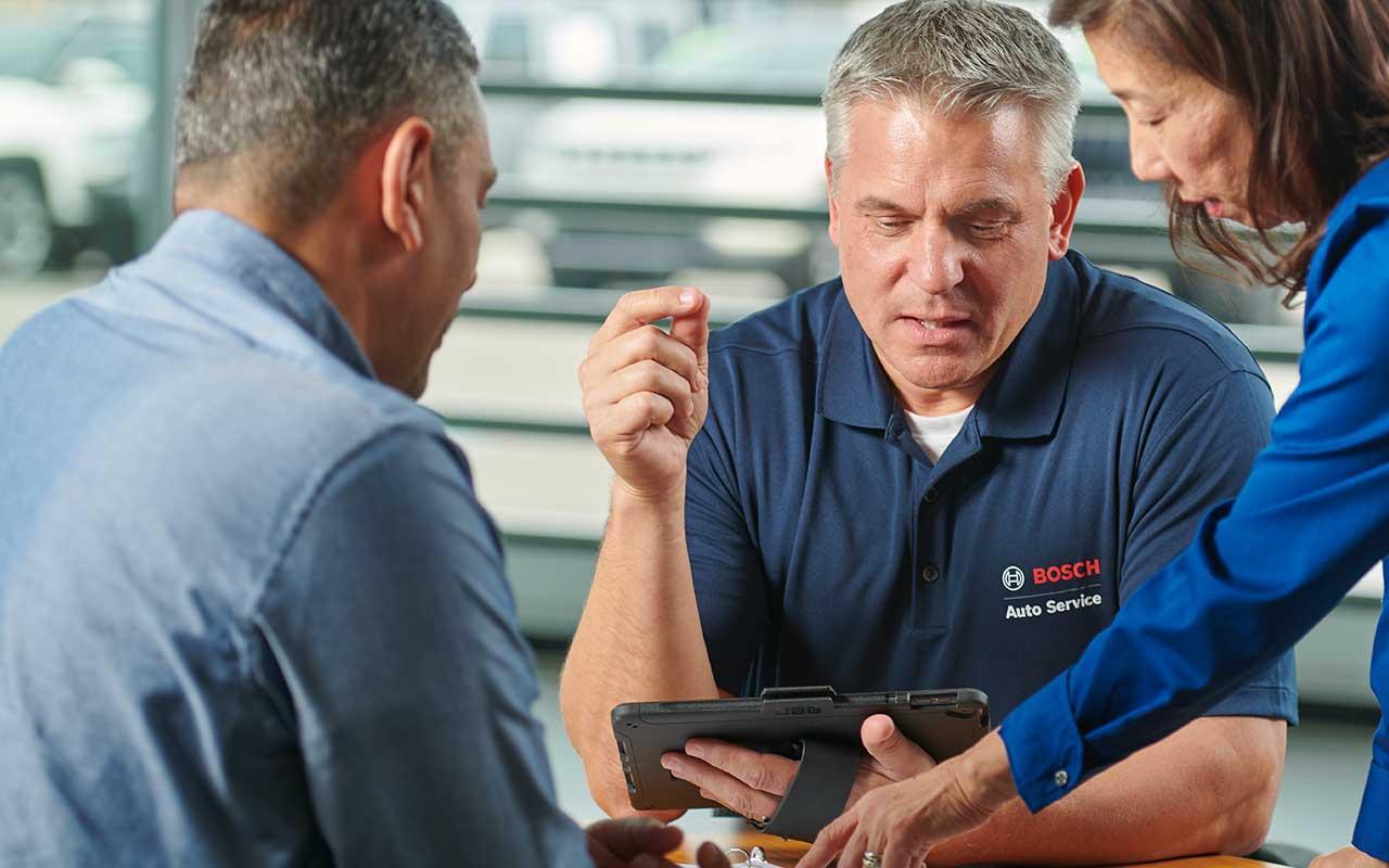 Bosch Auto Service consultant speaking with shop owners about franchise opportunity