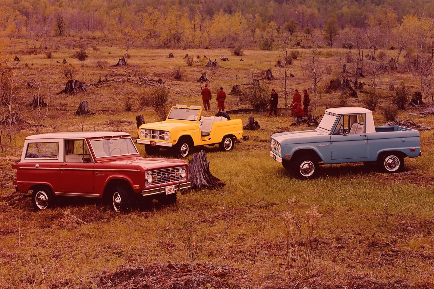 3 Old Ford Bronco models in a field