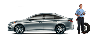 Gray Hyundai sedan with service man and tire Gray Hyundai sedan with service man and tire