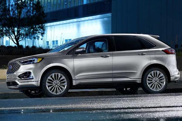 2022 Ford Edge Titanium shown in Iconic Silver parked in front of a building
