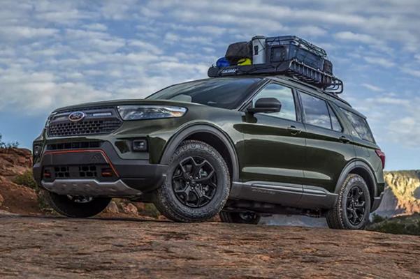 2022 Ford Explorer with Outfitters Cargo - Mega Warrior roof rack filled with equipment parked in a desert.
